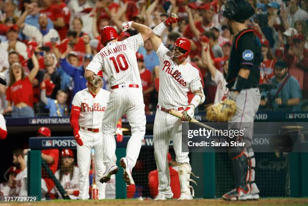 Realmuto celebrates with Nick Castellanos of the Philadelphia Phillies after hitting a solo home run during the fourth inning against the Miami...