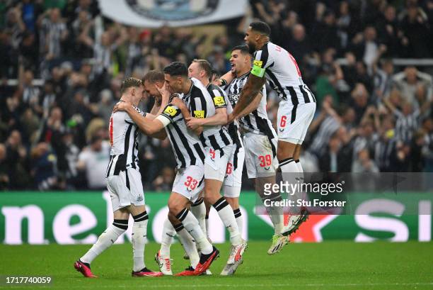 Newcastle player Dan Burn celebrates with team mates after scoring the second goal, which was given after a lengthy VAR Decision during the UEFA...