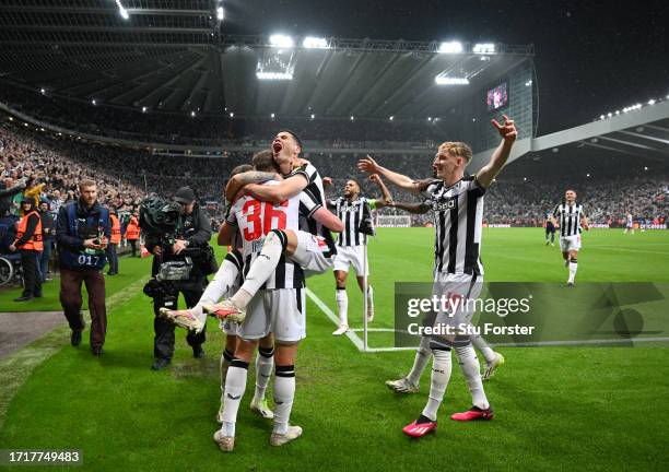 Newcastle players Miguel Almiron and Anthony Gordon celebrate the third Newcastle goal scored by Sean Longstaff during the UEFA Champions League...