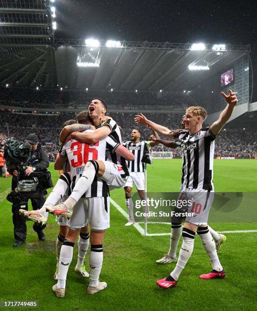 Newcastle players Miguel Almiron and Anthony Gordon celebrate the third Newcastle goal scored by Sean Longstaff during the UEFA Champions League...