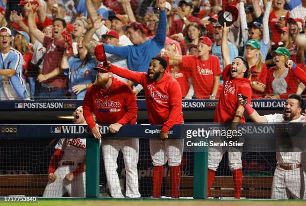 The Philadelphia Phillies dugout celebrates after a solo home run by J.T. Realmuto during the fourth inning against the Miami Marlins in Game Two of...