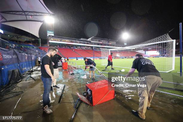 Dallas grounds crew work to repair damage caused by severe storms before the MLS game between Dallas and the Colorado Rapids at Toyota Stadium on...