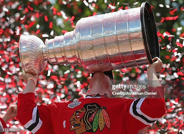 Bryan Bickell of the Chicago Blackhawks kisses the Stanley Cup Trophy during the Blackhawks Victory Parade and Rally on June 28, 2013 in Chicago,...