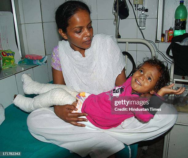 Anganwadi worker carrying a little girl who was rescued from Kedarnath at Doon district hospital on June 28, 2013 in Dehradun, India. So far more...