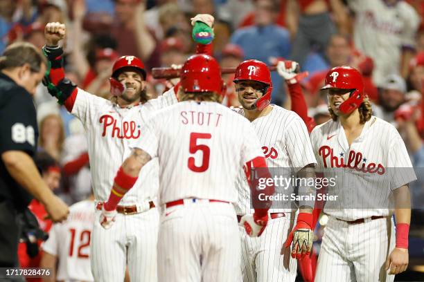 Bryson Stott of the Philadelphia Phillies celebrates with teammates after hitting a grand slam during the sixth inning against the Miami Marlins in...