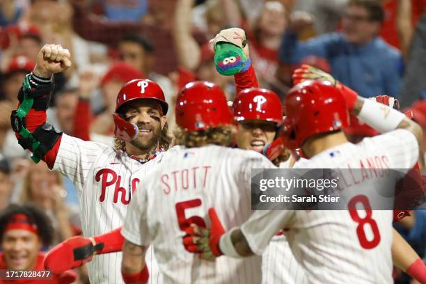 Bryson Stott of the Philadelphia Phillies celebrates with teammates after hitting a grand slam during the sixth inning against the Miami Marlins in...