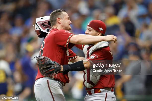 Paul Sewald of the Arizona Diamondbacks celebrates with Jose Herrera after defeating the Milwaukee Brewers 5-2 in Game Two of the Wild Card Series at...