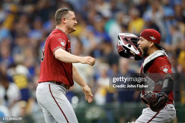 Paul Sewald of the Arizona Diamondbacks celebrates with Jose Herrera after defeating the Milwaukee Brewers 5-2 in Game Two of the Wild Card Series at...