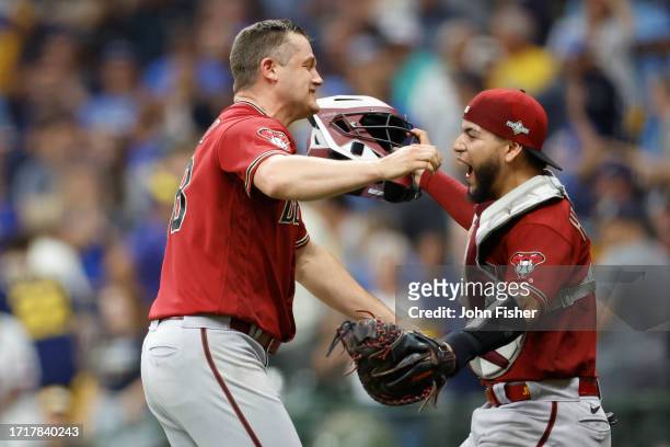 Paul Sewald of the Arizona Diamondbacks celebrates with Jose Herrera after defeating the Milwaukee Brewers 5-2 in Game Two of the Wild Card Series at...