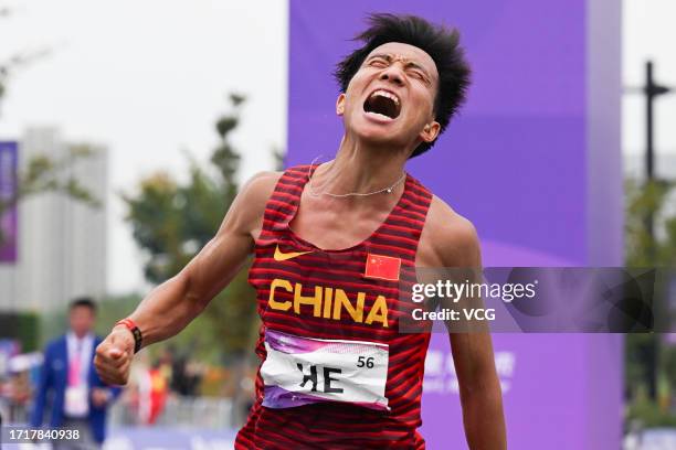 He Jie of China celebrates after winning the Athletics - Men's Marathon Final on day 12 of the 19th Asian Games at Smart New World Qiantang River...