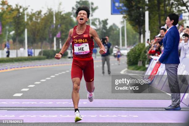 He Jie of China celebrates after winning the Athletics - Men's Marathon Final on day 12 of the 19th Asian Games at Smart New World Qiantang River...