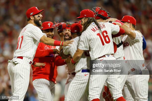 The Philadelphia Phillies celebrate after defeating the Miami Marlins 7-1 in Game Two of the Wild Card Series at Citizens Bank Park on October 04,...