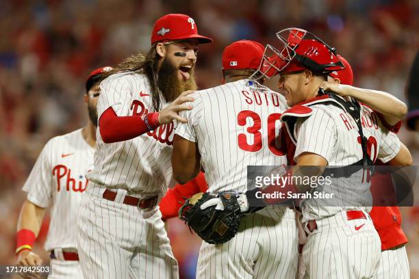 Brandon Marsh, Gregory Soto and J.T. Realmuto of the Philadelphia Phillies celebrate after defeating the Miami Marlins 7-1 in Game Two of the Wild...