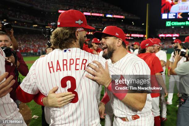 Bryce Harper of the Philadelphia Phillies celebrates with Kyle Schwarber after defeating the Miami Marlins 7-1 in Game Two of the Wild Card Series at...
