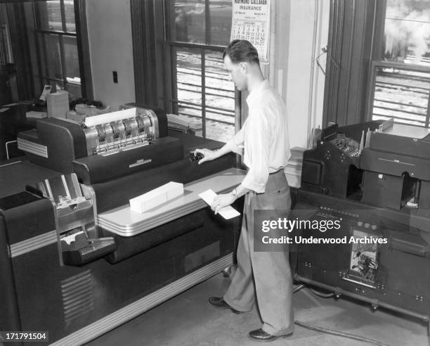 Worker using a large IBM Accounting Machine with punch cards at the Erie Railroad offices, Cleveland, Ohio, January 1951.