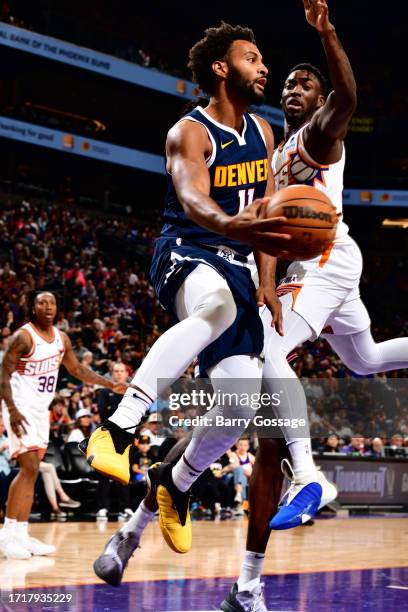 Braxton Key of the Denver Nuggets drives to the basket during the game against the Phoenix Suns on October 10, 2023 at Footprint Center in Phoenix,...