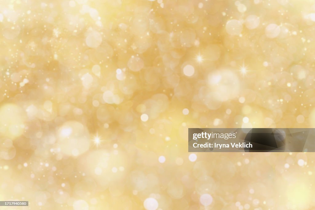 Sparkling Background with Yellow Beige Bokeh made of Elegant Gold Christmas Lights.