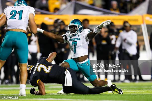 Keonte Lusk of the Coastal Carolina Chanticleers reacts after breaking up a pass to Kaedin Robinson of the Appalachian State Mountaineers during a...