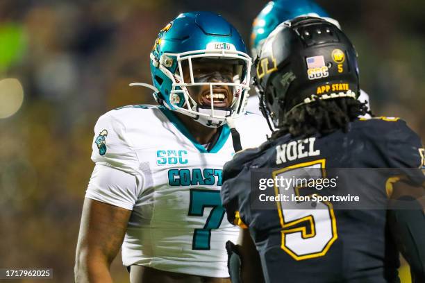 Keonte Lusk of the Coastal Carolina Chanticleers talks to Nate Noel of the Appalachian State Mountaineers after a play during a football game at Kidd...