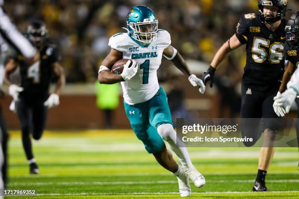 Braydon Bennett of the Coastal Carolina Chanticleers runs the ball during a football game against the Appalachian State Mountaineers at Kidd Brewer...