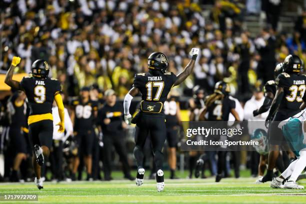 Jalik Thomas and Jarrett Paul of the Appalachian State Mountaineers react after a turnover on downs during a football game against the Coastal...