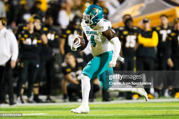 Beasley of the Coastal Carolina Chanticleers runs the ball during a football game against the Appalachian State Mountaineers at Kidd Brewer Stadium...