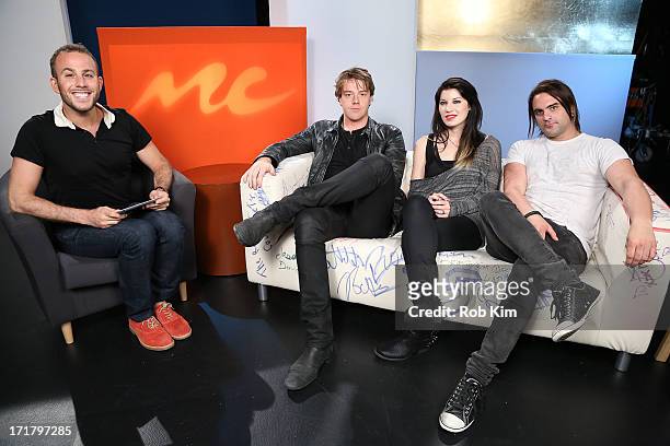 Host Micah Jesse with Shimon Moore, Emma Anzai and Mark Goodwin of Sick Puppies visit "U&A" at Music Choice on June 28, 2013 in New York City.