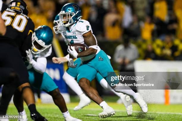 Braydon Bennett of the Coastal Carolina Chanticleers runs the ball during a football game against the Appalachian State Mountaineers at Kidd Brewer...