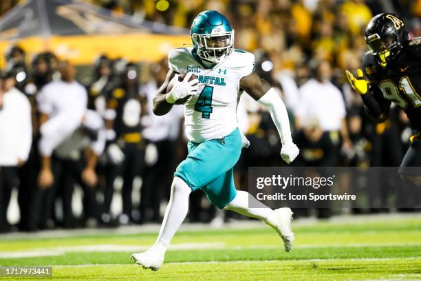 Beasley of the Coastal Carolina Chanticleers runs the ball during a football game against the Appalachian State Mountaineers at Kidd Brewer Stadium...