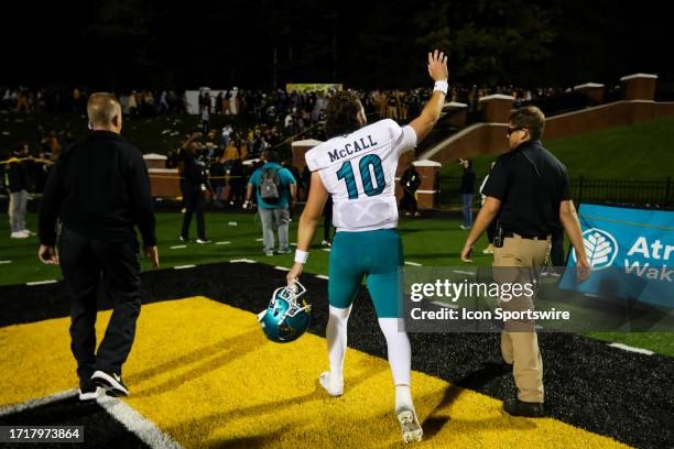 Grayson McCall of the Coastal Carolina Chanticleers waves to Appalachian State Mountaineers fans after a football game at Kidd Brewer Stadium in...