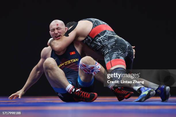 Rustam Assakalov of Uzbekistan and Uzur Dzhuzupbekov of Kyrgyzstan compete during the Men's Greco-Roman 97Kg Repechage Round match Wrestling event...