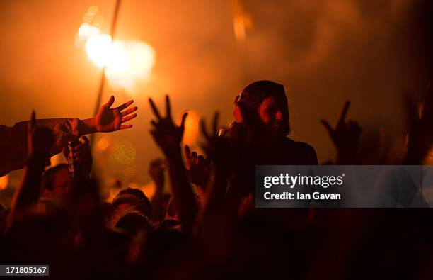 The crowd enjoy the atmosphere as the Arctic Monkeys performs live on the Pyramid Stage at day 2 of the 2013 Glastonbury Festival at Worthy Farm on...