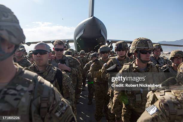 Army soldiers from the 101st Airborne Division line up in back of a C-17 cargo plane May 11, 2013 at Bagram Air Base, Afghanistan. After flying from...