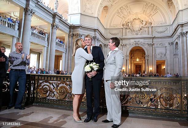 Same-sex couple Sandy Stier and Kris Perry kiss their son Elliot Perry after they were married at San Francisco City Hall by California Attorney...