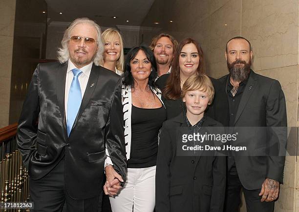 Barry Gibb and Linda Gibb and family and family attending the Nordoff Robbins Silver Clef Awards at London Hilton on June 28, 2013 in London, England.
