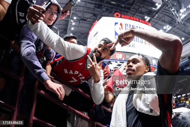 Scottie Barnes of the Toronto Raptors poses for a photo with fans after the game against the Sacramento Kings on October 8, 2023 at the Rogers Arena...