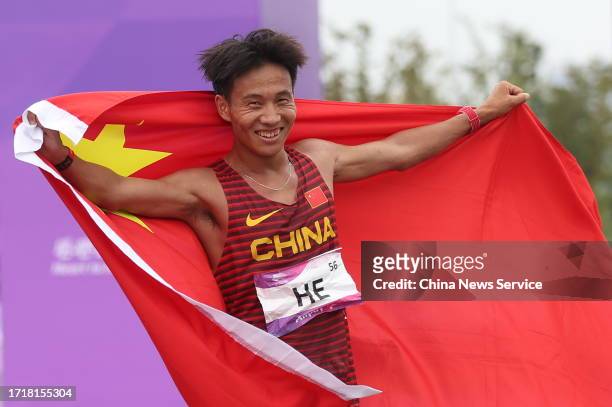 He Jie of Team China celebrates after winning the Athletics - Men's Marathon Final on day 12 of the 19th Asian Games at Smart New World Qiantang...