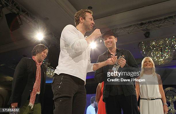 Nick McCabe, Chris Martin, Jonny Buckland and Gaby Rosalyn during Coldplay presentation of the Royal Albert Hall Best British Act Award at the...