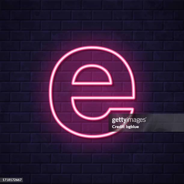 letter e. glowing neon icon on brick wall background - letter e icon stock illustrations