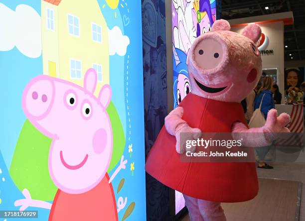 Peppa Pig character poses next to a poster at the Hasbro stand during the Brand Licensing Europe at ExCel on October 04, 2023 in London, England....