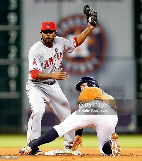 Erick Aybar of the Los Angeles Angels tags out Ronny Cedeno of the Houston Astros attempting to steal second base in the fifth inning at Minute Maid...