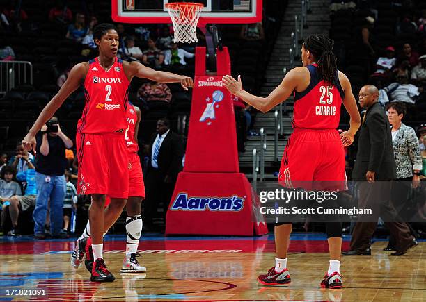 Michelle Snow and Monique Currie of the Washington Mystics celebrate after a basket during the game against the Atlanta Dream at Philips Arena on...