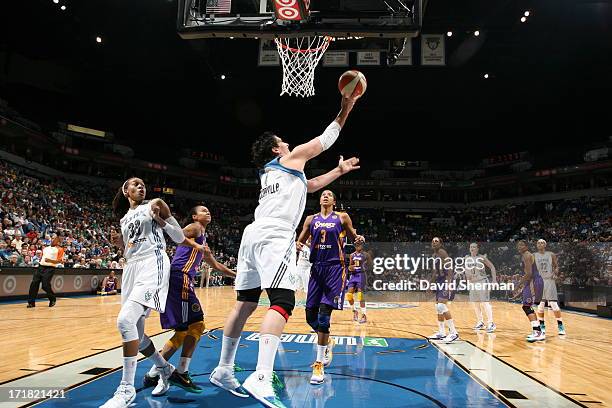 Janel McCarville of the Minnesota Lynx goes for a reverse layup Candace Parker of the the Los Angeles Sparks during the WNBA game on June 28, 2013 at...