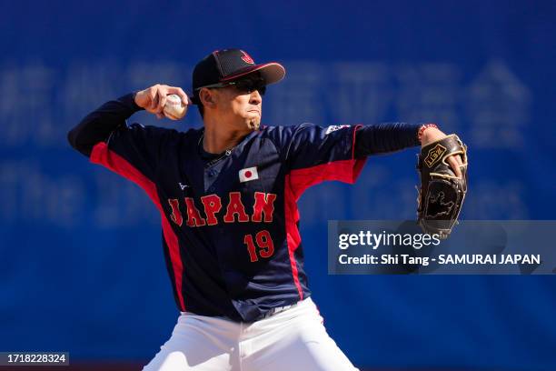 Katsutoshi Satake of Team Japan throws a pitch in the 8th inning during the baseball Super Round game Japan and South Korea on day ten of the 19th...