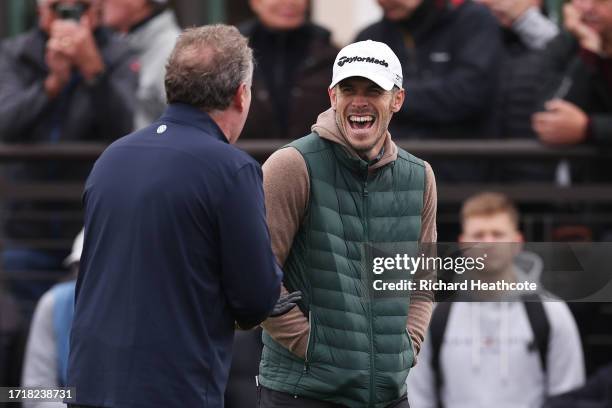 Former Footballer, Gareth Bale laughs with Journalist, Piers Morgan on the first tee during Day One of the Alfred Dunhill Links Championship at...