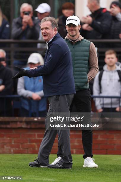 Former Footballer, Gareth Bale laughs with Journalist, Piers Morgan on the first tee during Day One of the Alfred Dunhill Links Championship at...