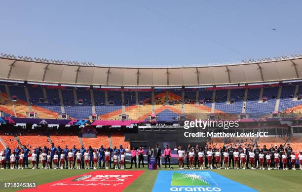 Players of England and New Zealand line up for the National Anthems ahead of the ICC Men's Cricket World Cup India 2023 between England and New...