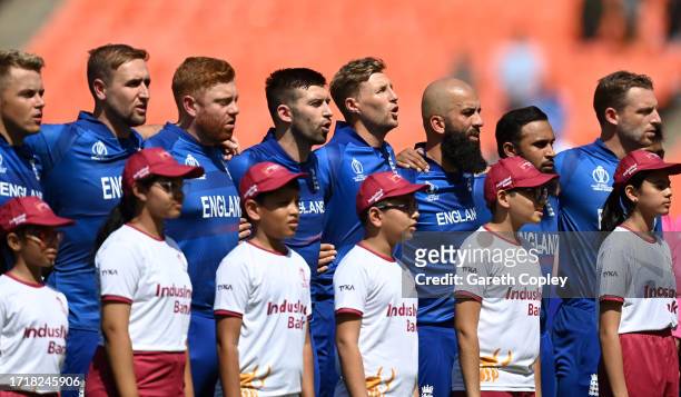 Players of England line up for the National Anthems ahead of the ICC Men's Cricket World Cup India 2023 between England and New Zealand at Narendra...