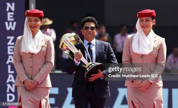 Former Indian Cricketer Sachin Tendulkar carries the ICC Cricket World Cup Trophy ahead of the ICC Men's Cricket World Cup India 2023 between England...