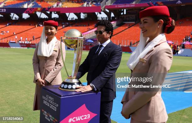 Former Indian Cricketer Sachin Tendulkar carries the ICC Cricket World Cup Trophy ahead of the ICC Men's Cricket World Cup India 2023 between England...